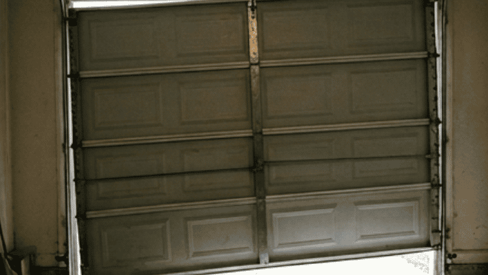 Garage door partially open after loud bang caused by broken torsion spring